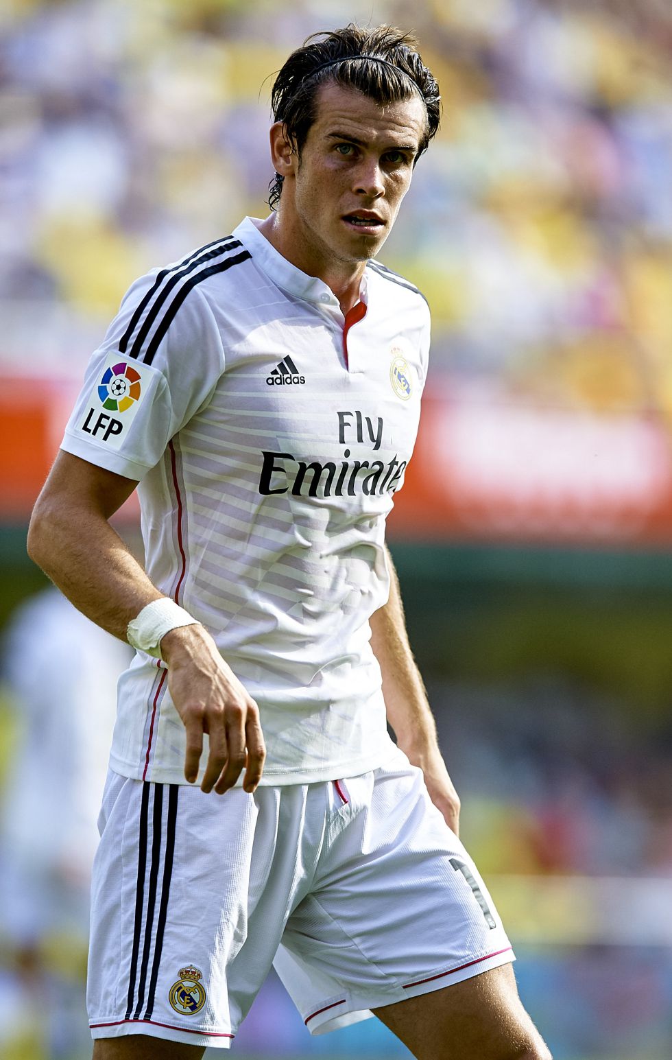 Bale Hairstyle With Headband And Slicked Back Hair