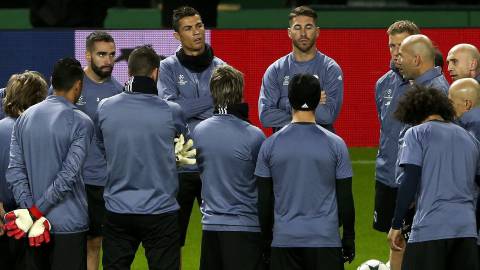 Los jugadores del Real Madrid escuchan la charla de Zidane sobre el césped del Alvalade, donde juega este martes ante el Sporting de Portugal.